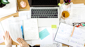 overhead shot of a desk with papers on it